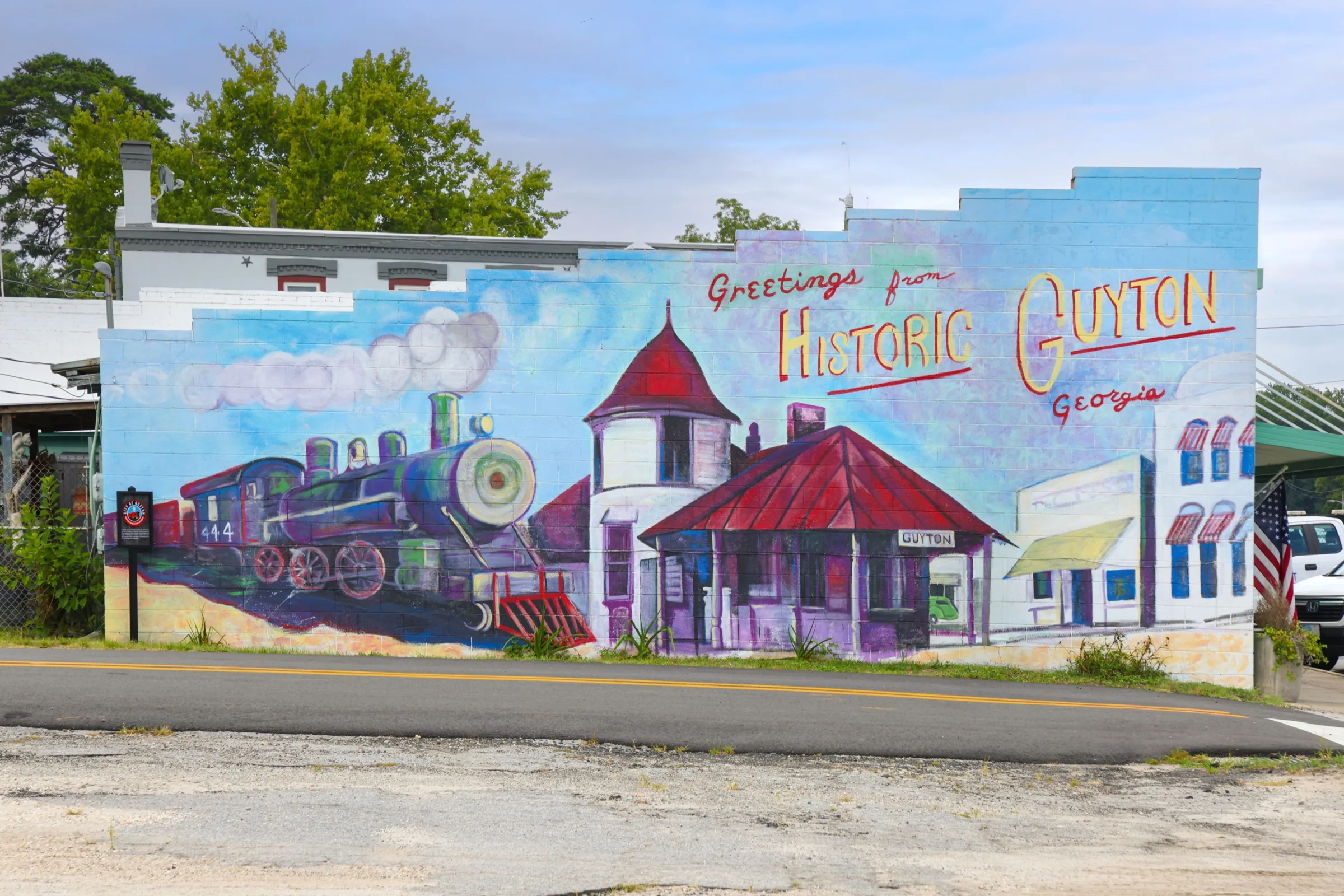 Greetings from Historic Guyton mural featuring local landmarks.