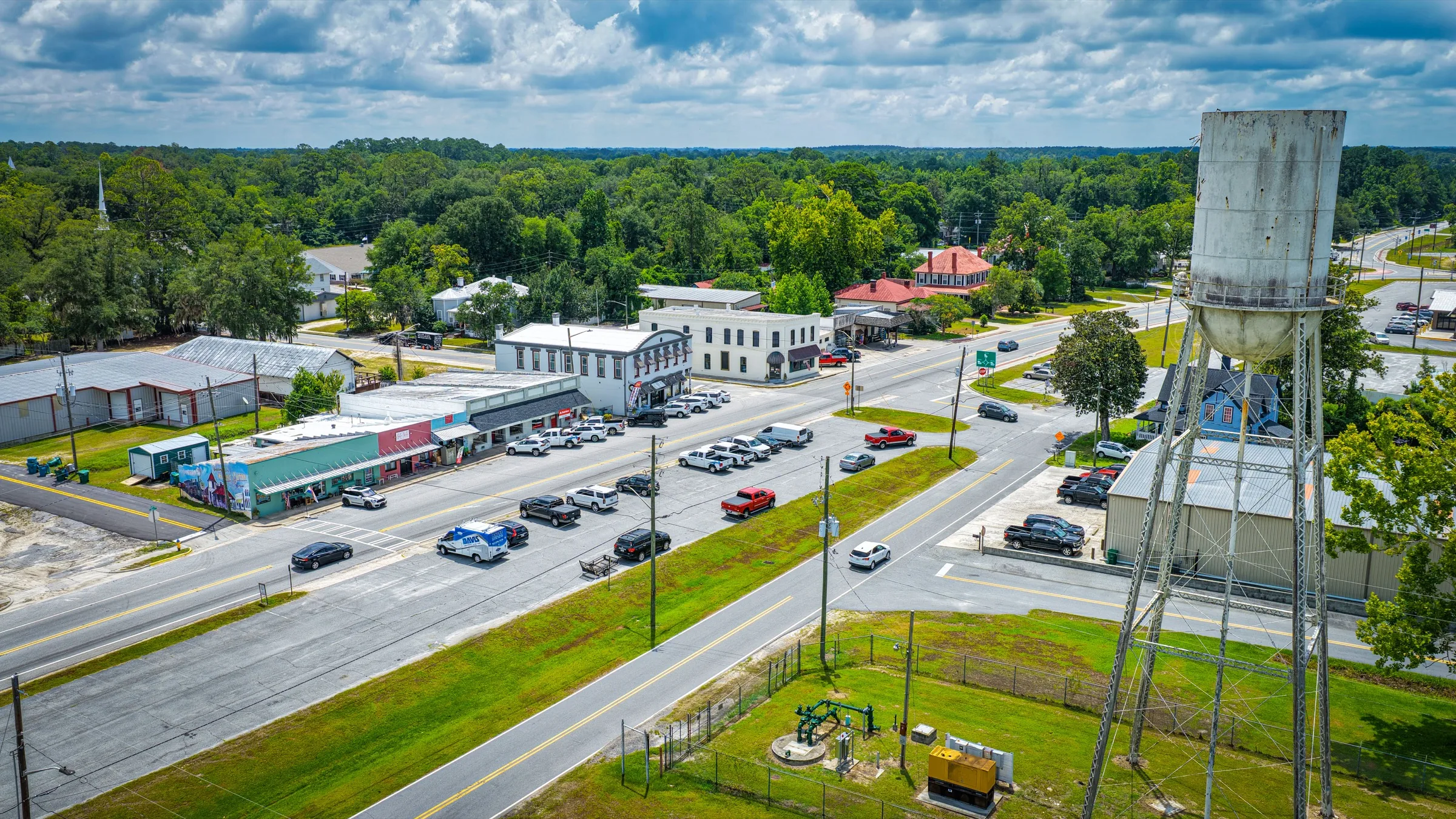 Aerial view of local businesses, streets, and a water tower.