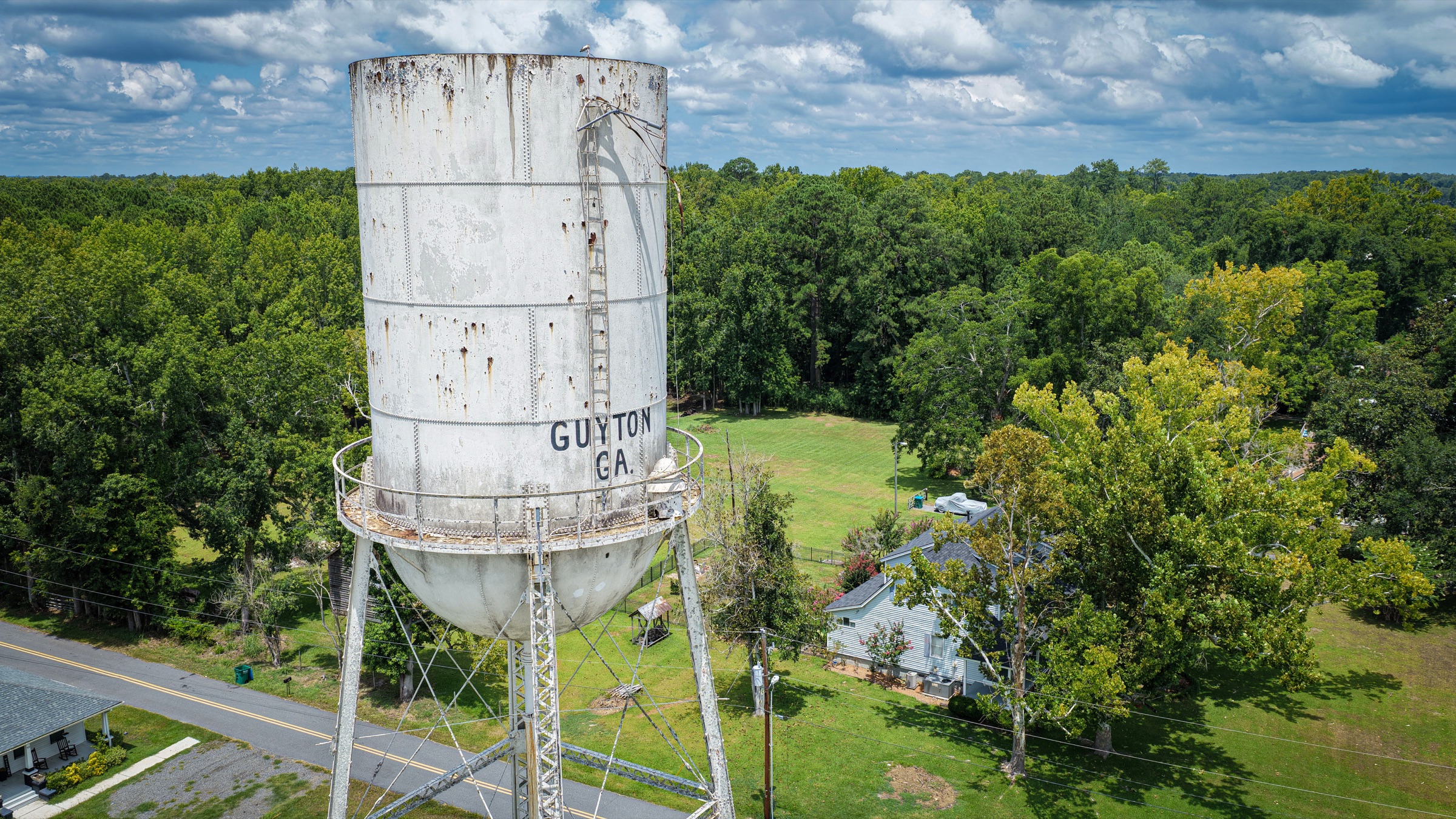 Historic Guyton water tower above the surrounding tree line.